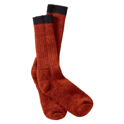 A pair of textured knit crew socks in a rust-orange color with a dark charcoal gray ribbed cuff, displayed against a solid white background.