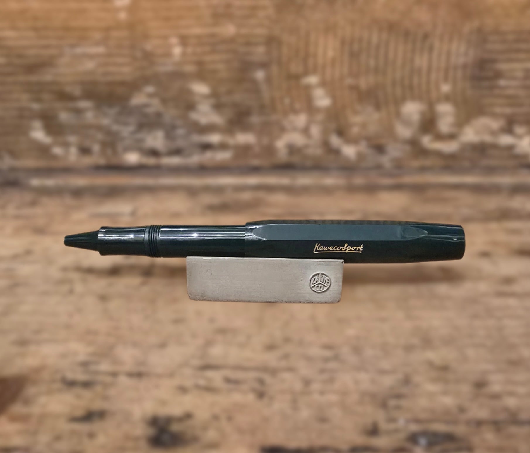 Dark Green Kaweco Sport Ballpoint Pen on wooden block on wooden step. Men's accessories salisbury