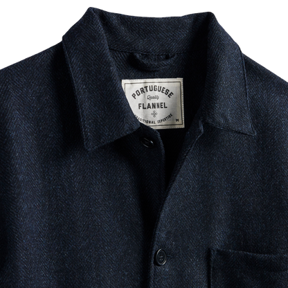 Close-up of a dark navy Portuguese flannel button-up shirt collar with a visible brand label.