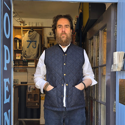 Man standing in front of a store with colorful glass door