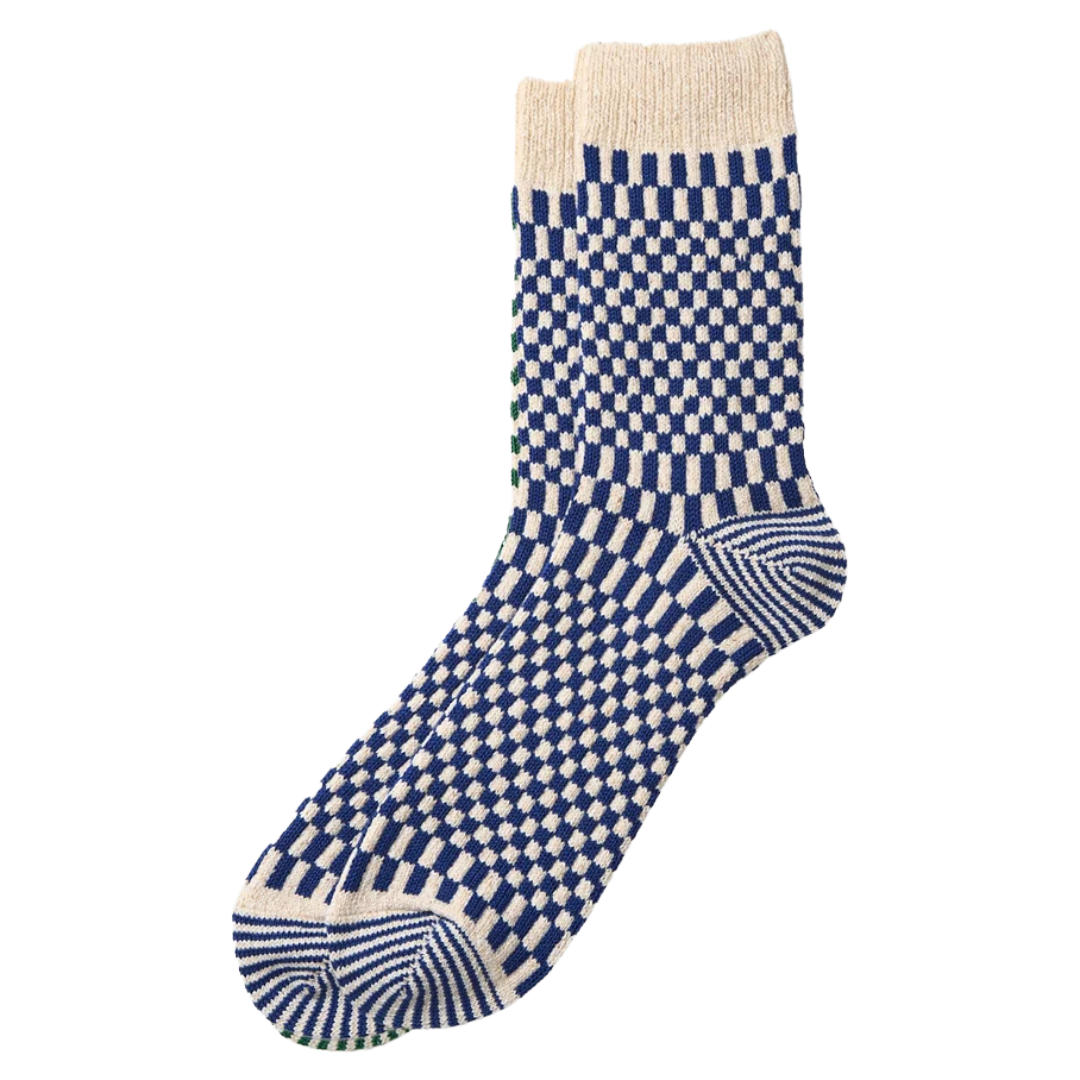 A pair of crew socks with a blue and off-white checkerboard pattern, featuring striped toe and heel details and a solid off-white ribbed cuff, shown on a plain white background.