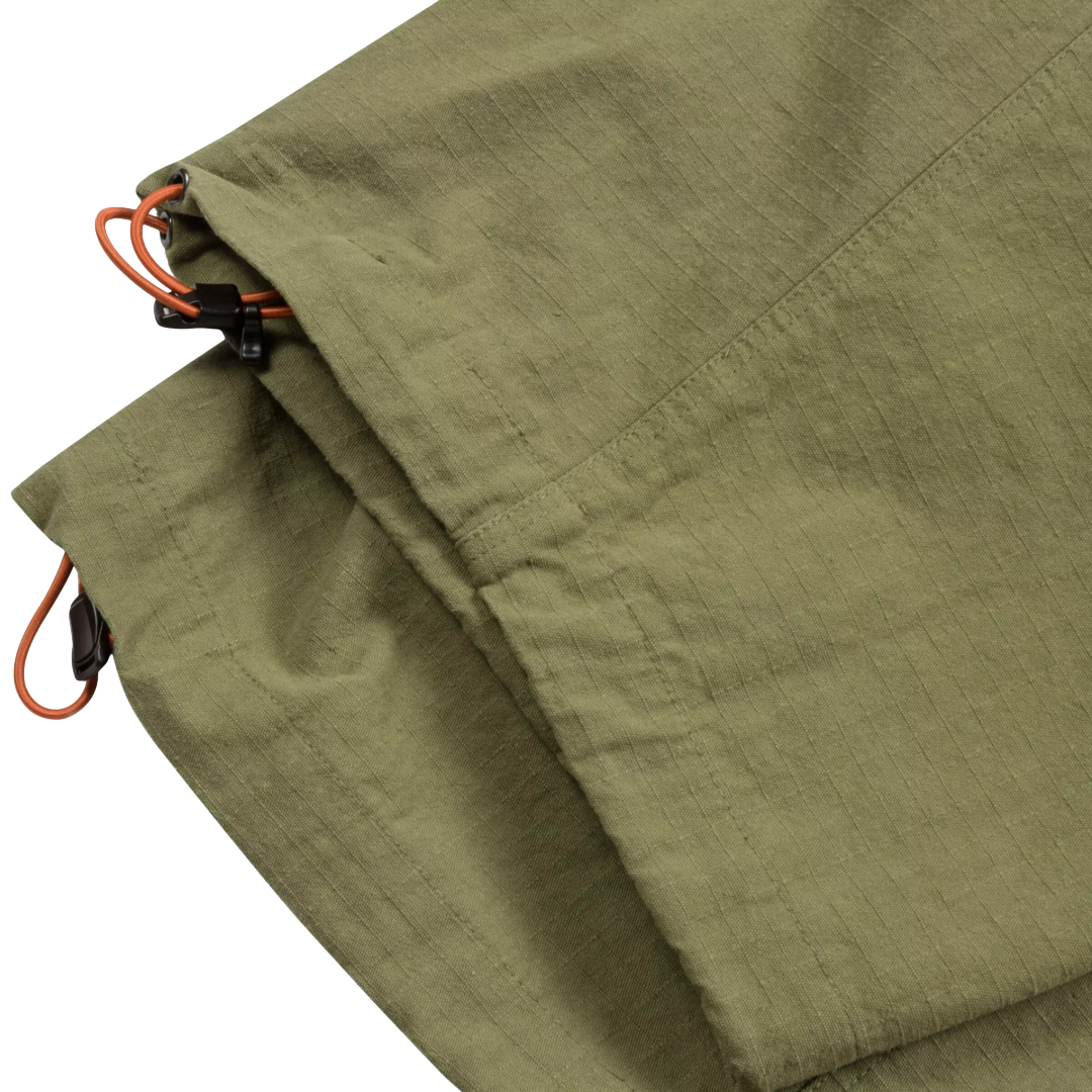 Close-up of olive green fabric with orange drawcord cords and black plastic clips on a white background.