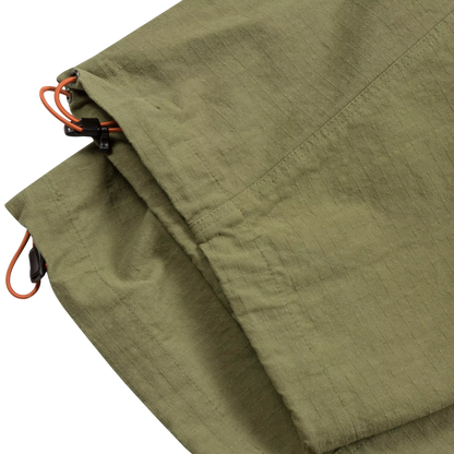 Close-up of olive green fabric with orange drawcord cords and black plastic clips on a white background.