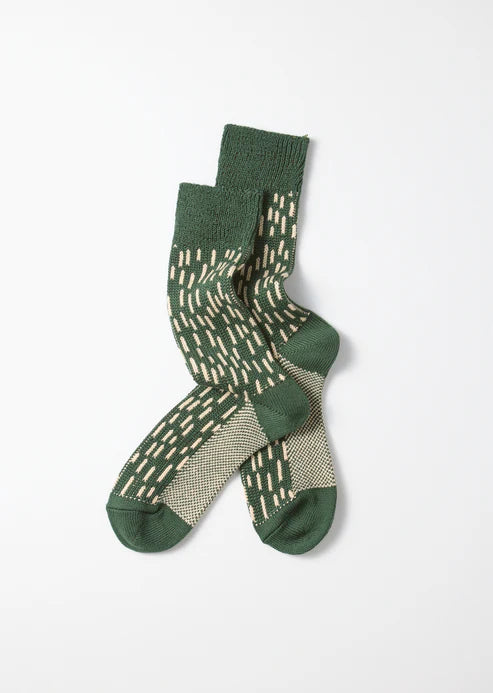 Green raindrop camo inspired sock with a low gauge knit that has a looser more visible style.