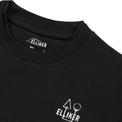 Close-up of a black crewneck t-shirt by Elliker, showing the inner neck label and a white graphic logo printed on the lower left chest.