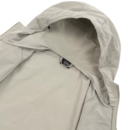 Close-up of a hooded jacket in a light gray and white micro-check pattern, showing the interior hood lining and a small black brand tag that reads ALOHA.