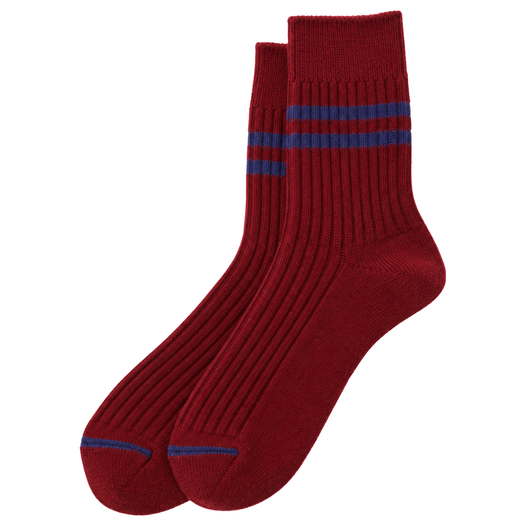 A pair of ribbed crew socks in deep red with two blue stripes near the cuff and a blue stripe on the toes, shown on a plain white background.