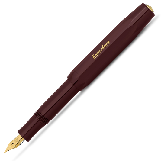 A Kuvings fountain pen in a deep burgundy barrel with gold accents, including the brand name 'Kuvings' on the cap and the nib. The pen is shown diagonally on a clean white background.