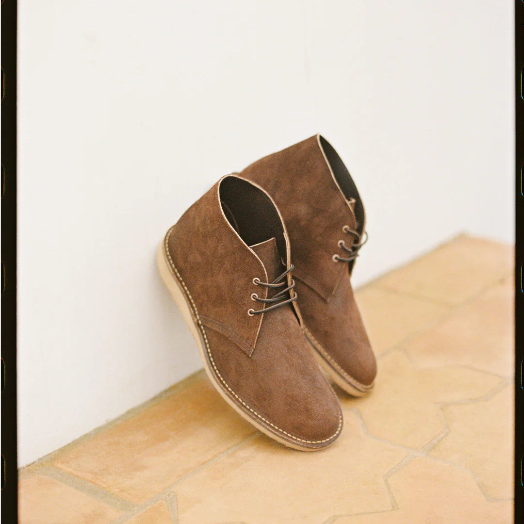 Brown Waxed Leather shoes on a light wooden surface with a white background
