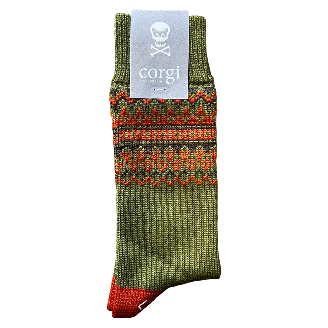 A single knit sock in olive green with a red and orange geometric pattern band and a red toe, shown on a white background with a gray paper tag that reads corgi.