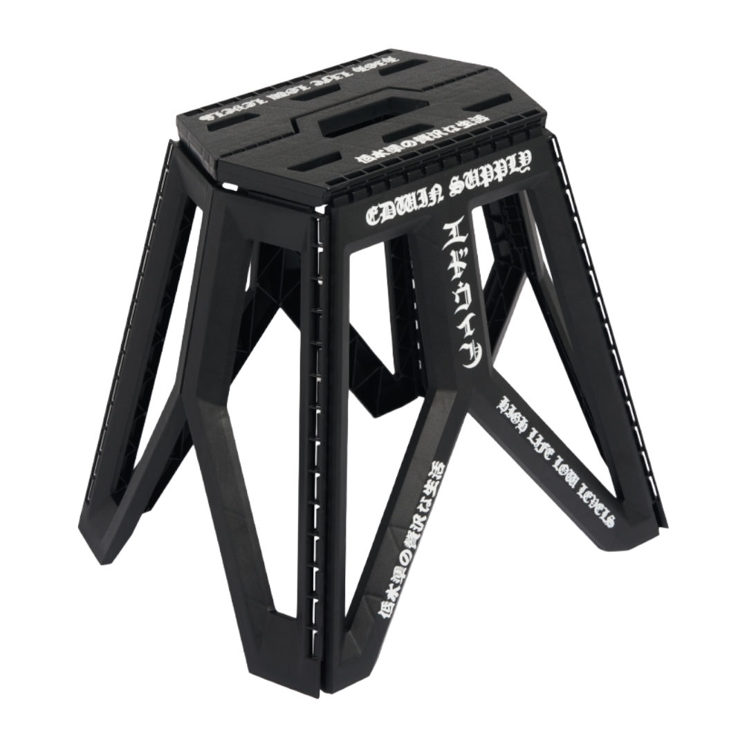 A black foldable step stool with white Japanese text printed on its side, shown on a clean white background.