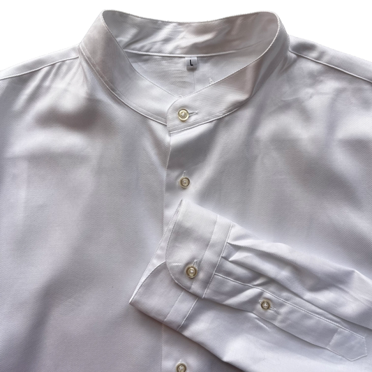 A close-up of a white long-sleeve shirt with a mandarin collar and button front, laid flat on a white background.