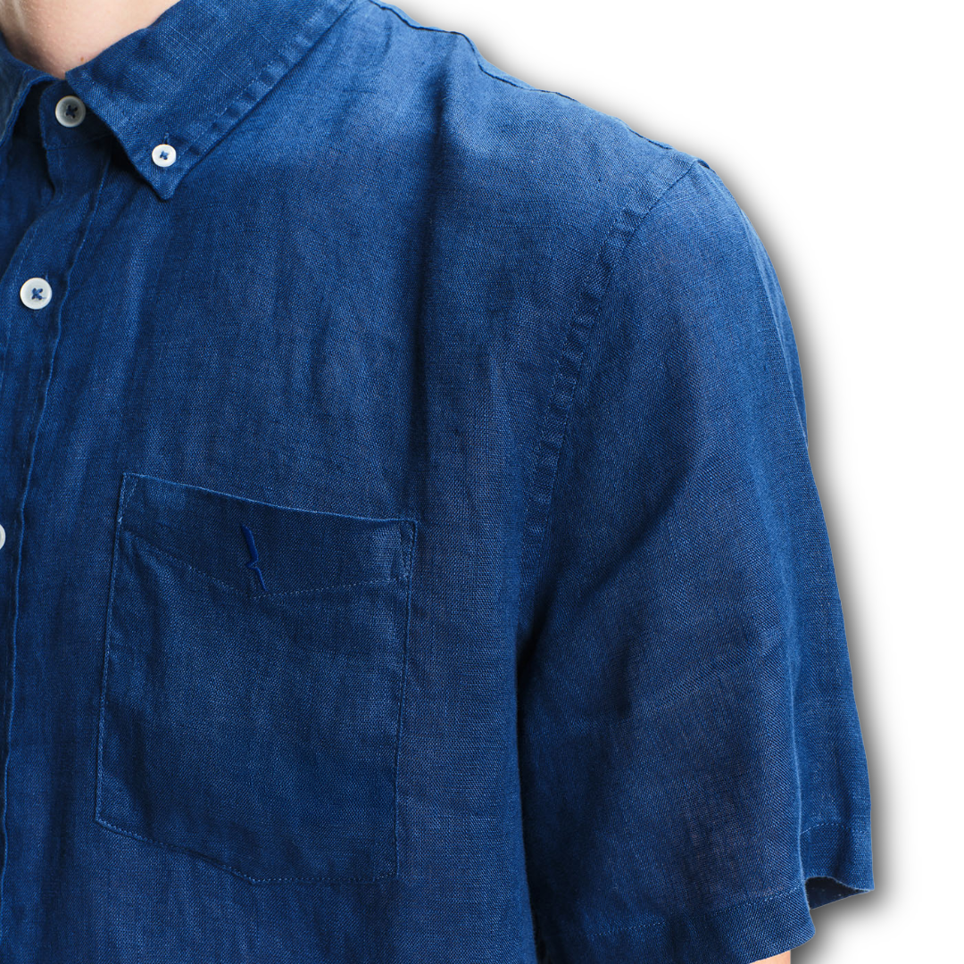 Corner close-up of an Aigle blue shirt with a pocket on a white background sold at Regent in Salisbury
