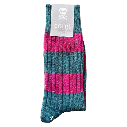 A single ribbed knit sock with horizontal stripes in teal and bright pink, featuring a gray paper tag with a skull logo and the brand name 'corgi'.