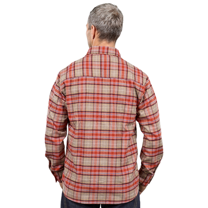 A man viewed from the back wearing a long-sleeve plaid button-up shirt in beige, red, and orange tones, paired with dark pants, against a plain white background.