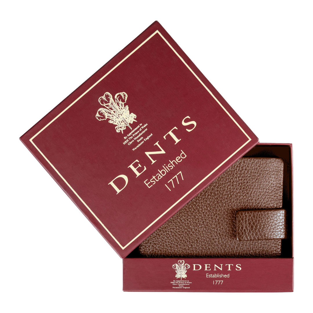 A brown textured leather wallet presented inside an open burgundy gift box with gold lettering that reads 'DENTS Established 1777'.