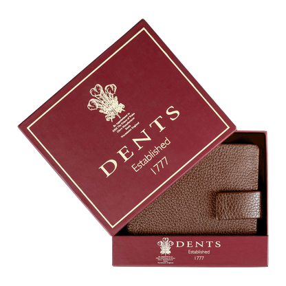 A brown textured leather wallet presented inside an open burgundy gift box with gold lettering that reads 'DENTS Established 1777'.