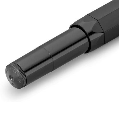 Close-up of a glossy black cylindrical product component, likely a pen or similar stationery item, shown on a clean white background.