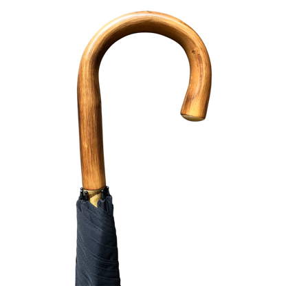 A close-up of a wooden cane handle with a curved, polished brown wood finish and a black fabric-wrapped grip, shown against a plain white background.