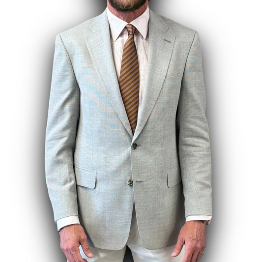 Light gray suit jacket with a striped tie on a plain background