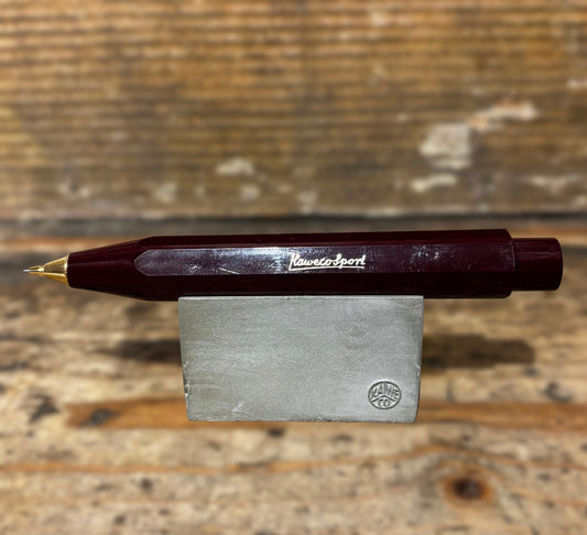 Burgundy Kaweco Ballpoint Pen on wooden block and wooden background