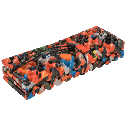 A rolled-up foam mat with a vibrant multicolor camouflage pattern in orange, black, gray, and blue, secured with a black drawstring, shown on a plain white background.