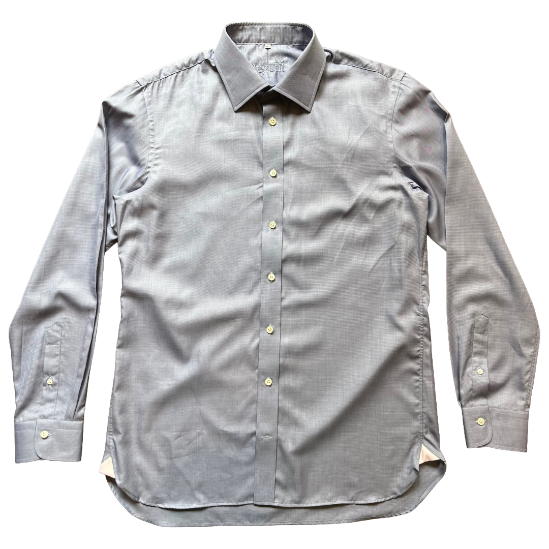 A light grey/ blue long-sleeve button-down shirt with a pointed collar and light-colored buttons, laid flat against a white background.