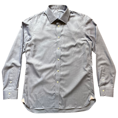 A light grey/ blue long-sleeve button-down shirt with a pointed collar and light-colored buttons, laid flat against a white background.