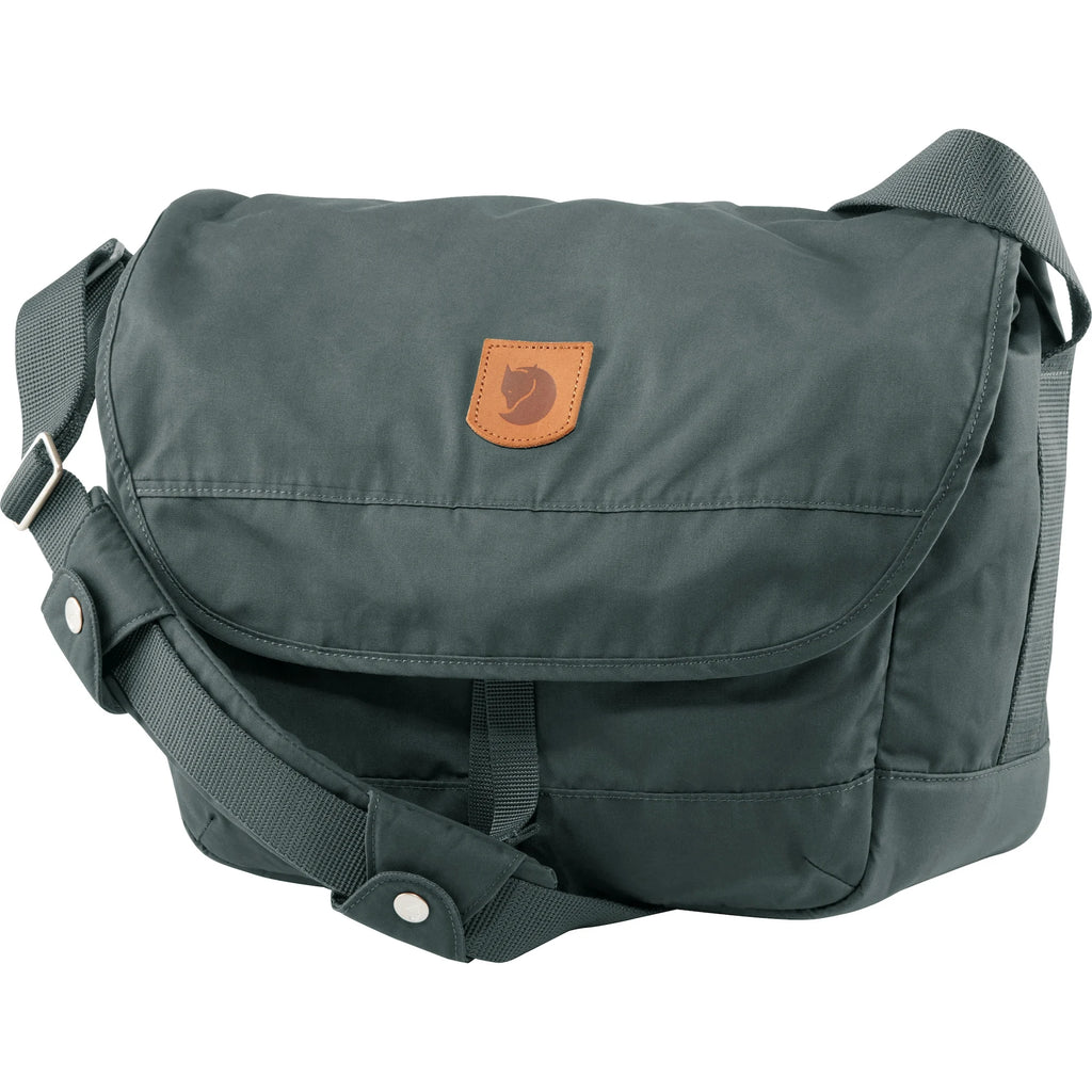 Dusk blue shoulder bag with shoulder strap and front flap logo on front flap.