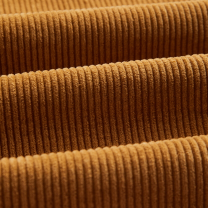 Close-up of a warm brown corduroy fabric with a ribbed texture and soft sheen.