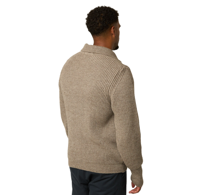 A man viewed from the back wearing a ribbed knit half-zip sweater in a warm taupe-beige color, paired with dark pants, against a plain white background.
