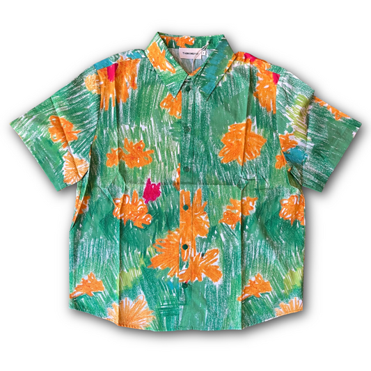 Colorful floral shirt with orange and pink flowers on a green background