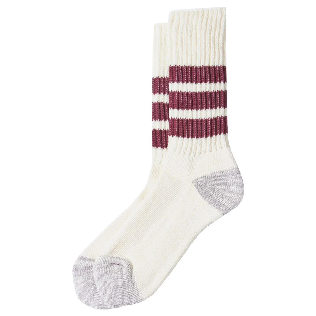A pair of cream-colored knit crew socks with three burgundy stripes on the leg and gray heels and toes, shown against a plain white background.