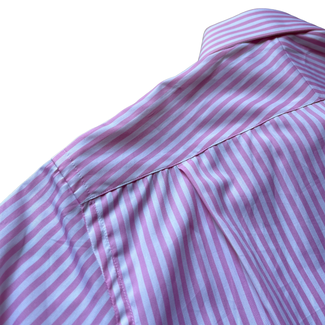 Close-up of a pink and white striped shirt showing the collar, shoulder seam, and fabric texture against a white background.