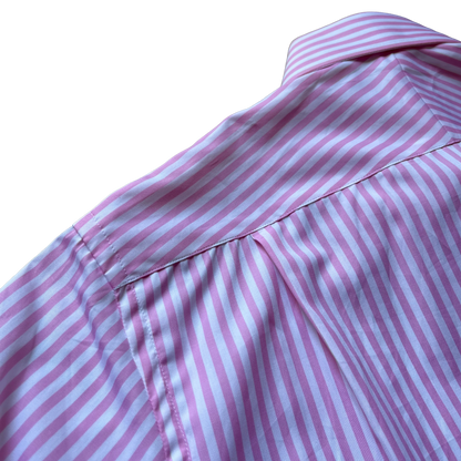 Close-up of a pink and white striped shirt showing the collar, shoulder seam, and fabric texture against a white background.