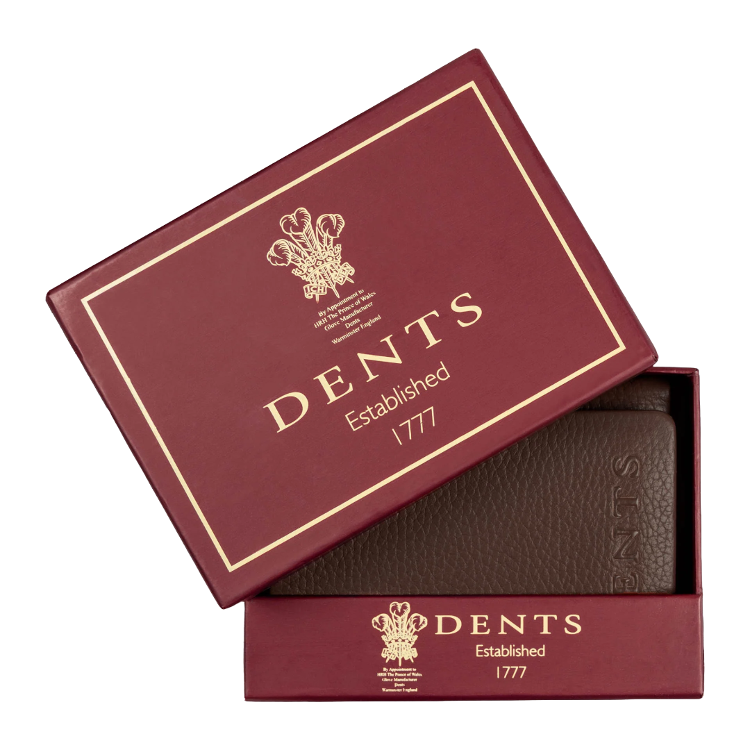 A dark brown textured leather wallet presented in a burgundy Dents brand gift box with gold foil lettering, shown on a clean white background.