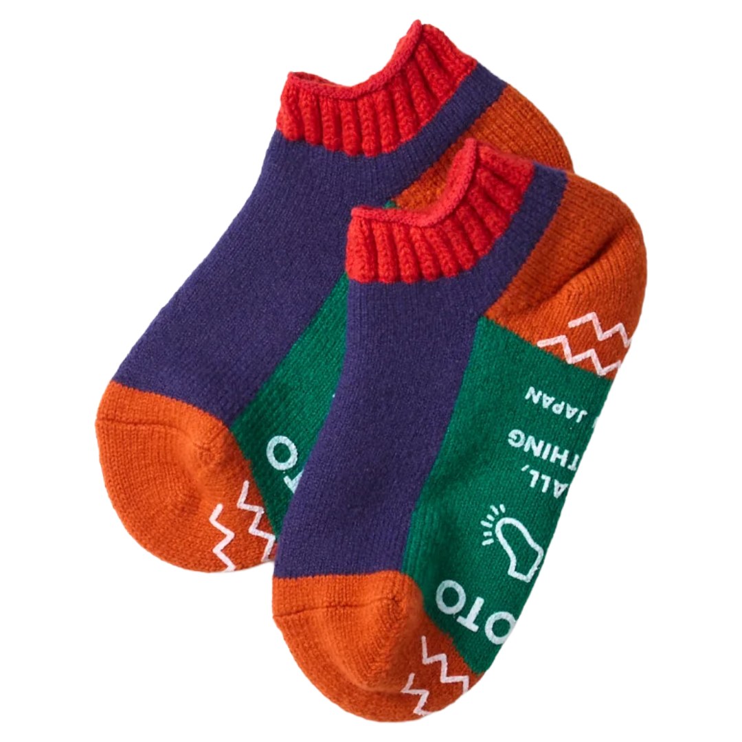 A pair of multicolor knit ankle socks with purple, green, orange, and red sections, featuring white printed text and geometric patterns, shown on a plain white background.