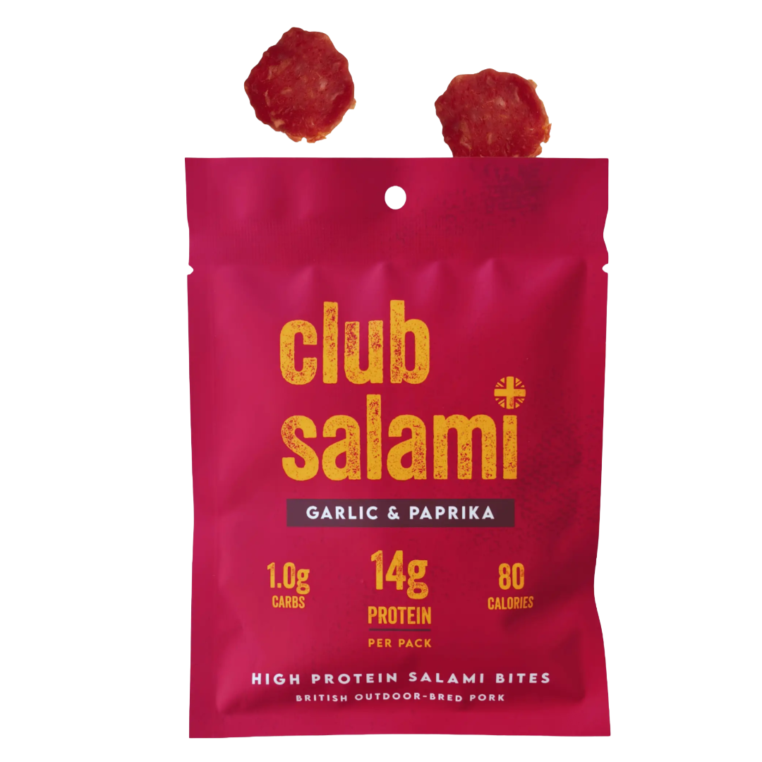 Club Salami Garlic & Paprika protein salami bites in a bright pink pouch with yellow text, shown on a white background with two salami slices above the package.
