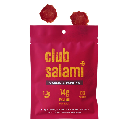 Club Salami Garlic & Paprika protein salami bites in a bright pink pouch with yellow text, shown on a white background with two salami slices above the package.