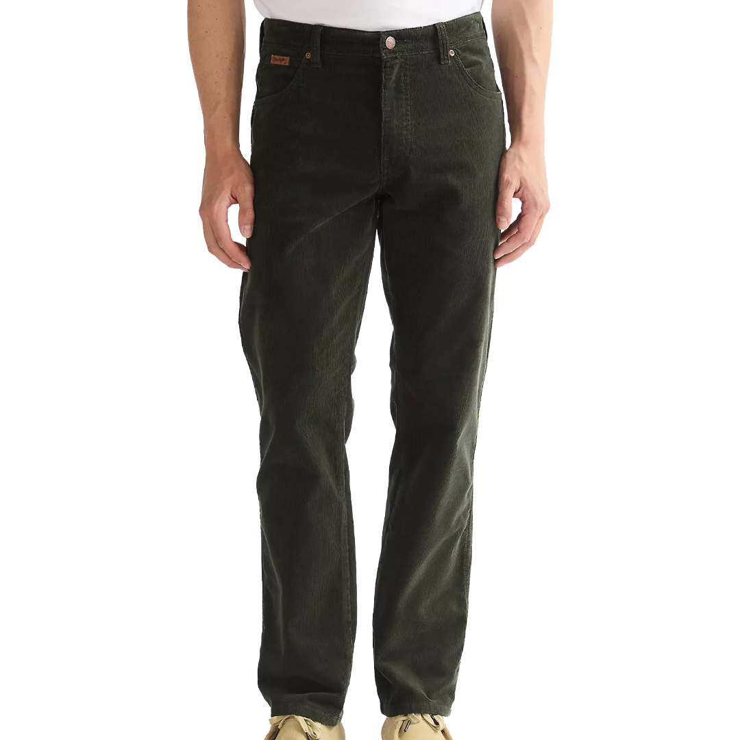 A person wearing dark olive green corduroy pants, shown from the waist down against a plain white background.