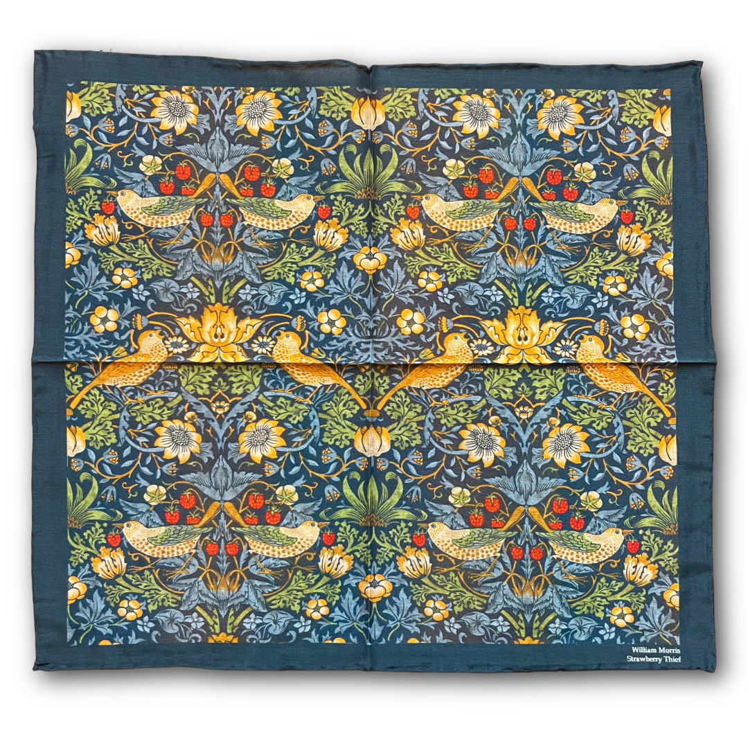 A square fabric scarf featuring a detailed William Morris-style floral and bird pattern in blue, green, yellow, and red, with a solid dark blue border.