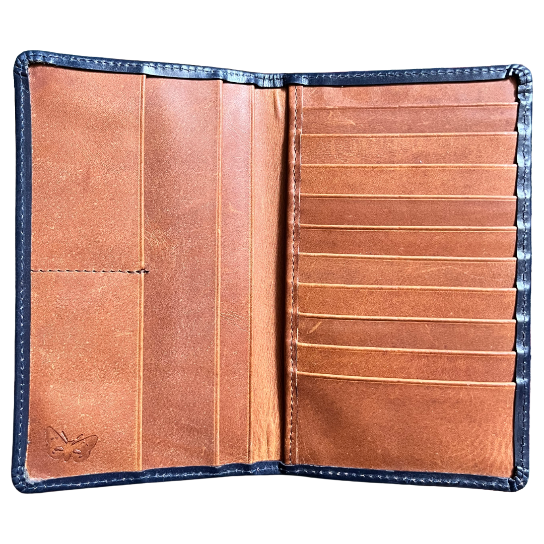 An open leather wallet or card holder showing its interior layout, with a warm tan-brown leather interior, multiple card slots on the right, a vertical divider on the left, and a stitched dark blue outer border.