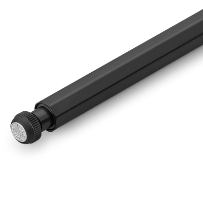 A close-up of a black metal pen with a knurled adjustment knob at one end, photographed on a clean white background.