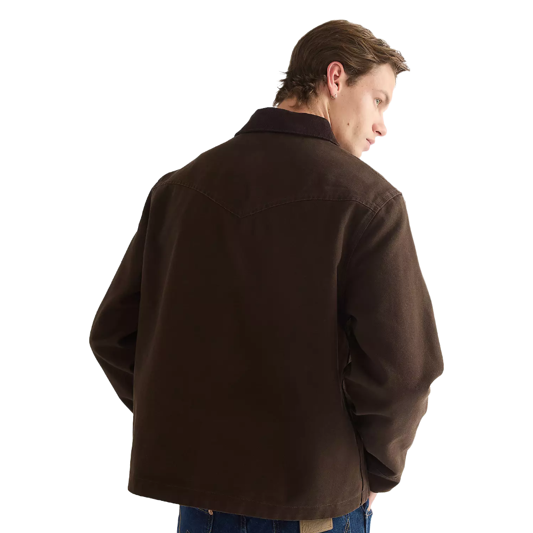 A man wearing a dark brown canvas utility jacket, shown from a three-quarters back view against a solid white background.