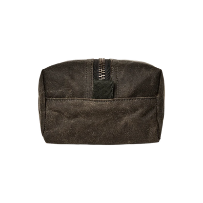 A dark brown waxed canvas zippered pouch with a front pocket and a black webbing pull tab, shown against a plain white background.