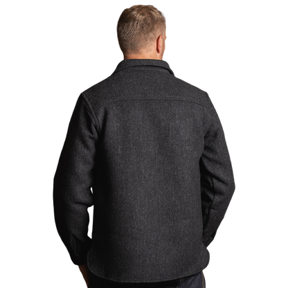 A man viewed from the back wearing a dark charcoal gray textured overshirt or jacket, shown against a plain white background.