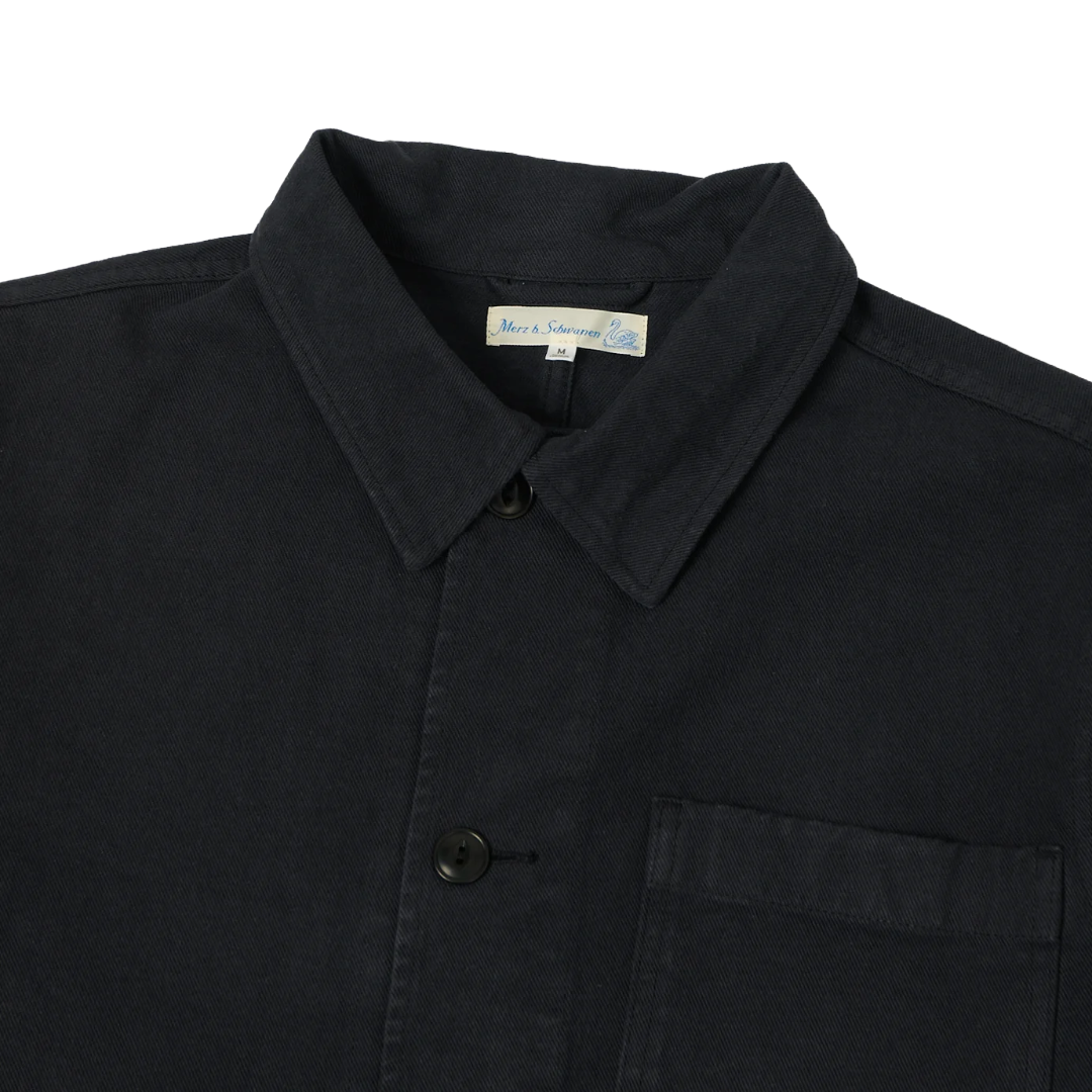 Close-up of a charcoal  cotton shirt jacket with a pointed collar, button front.