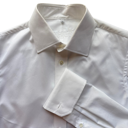 A close-up of a white long-sleeve dress shirt with a pointed collar, button front, and folded cuff, photographed against a bright white background.