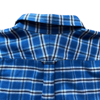 Close-up of a blue plaid flannel shirt showing the collar, back yoke, and button placket 