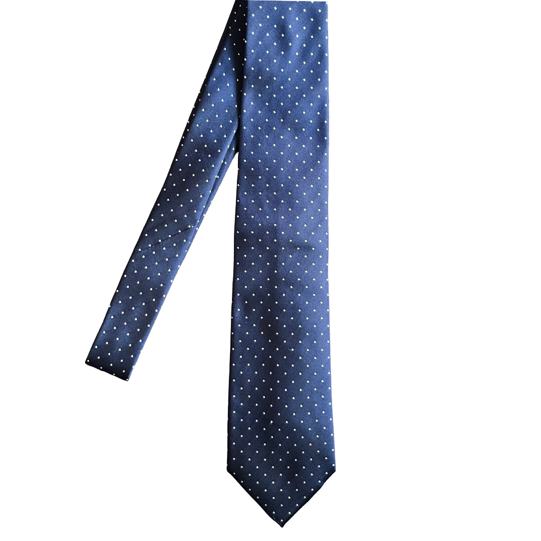 A classic necktie in navy blue with a small white polka dot pattern, shown against a plain white background.